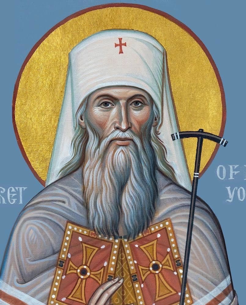 Icon of Saint Philaret of New York in white monastic klobuk with a red cross, holding a book, against a blue ground with a gold halo