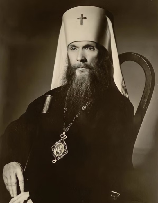 Seated portrait of Metropolitan Philaret in white klobuk and dark riassa, wearing a panagia